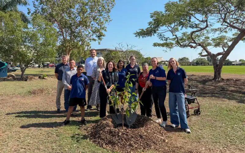 Staff and students at Darwin High School plant a banyan tree to commemorate the official launch of the school's new logo.