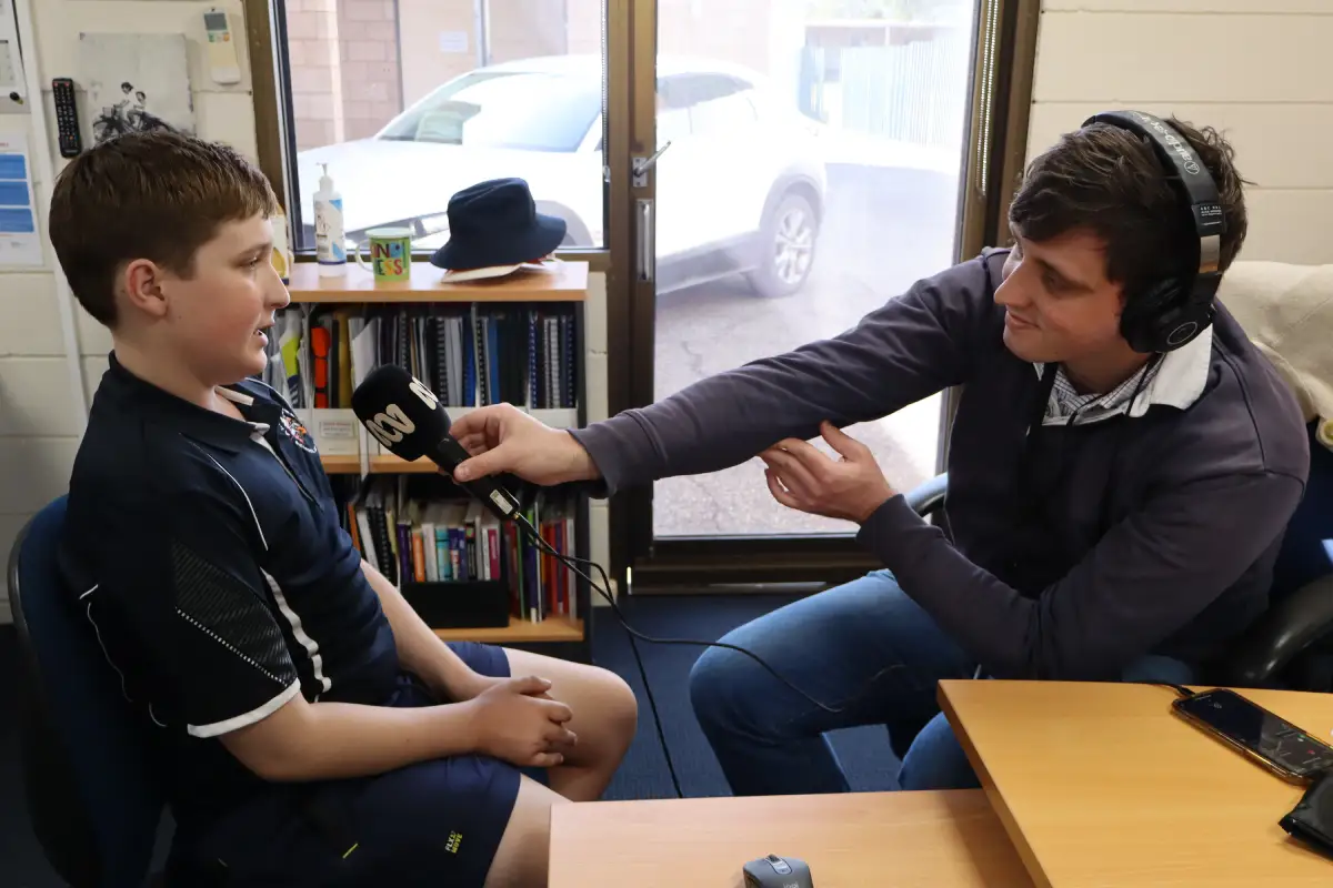Broadcaster interviewing student
