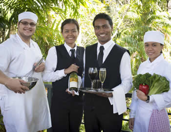 Two young women and two young men learing about hospitality in the 2010s 