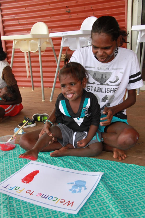 Mother with child and painting saying Welcome to FaFT